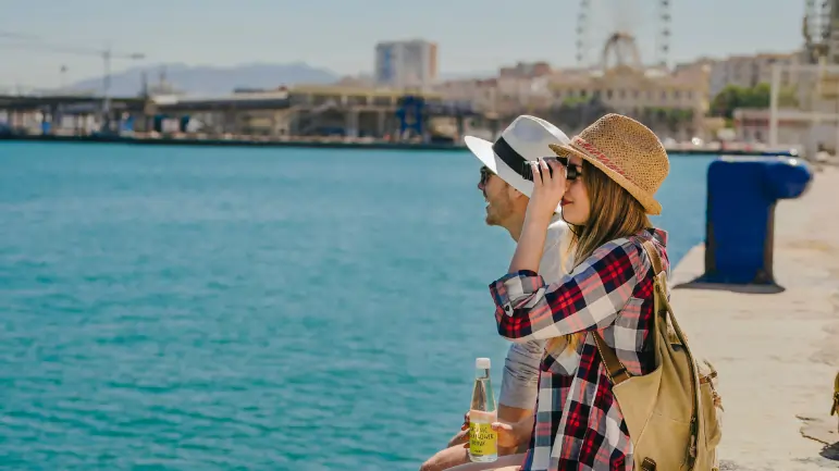 Couple enjoying waterfront views during an Abu Dhabi sightseeing tour while exploring the city’s attractions.